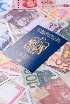 International passport of a citizen of United Arab Emirates against the paper banknotes