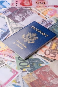 International passport of a citizen of USA on a against the background of paper banknotes of different countries