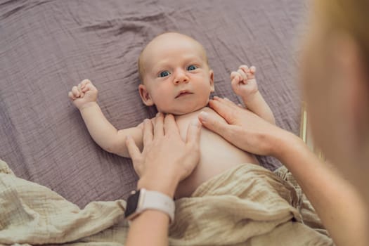 A mother gently massages her 1-month-old baby with baby oil after a bath. This tender moment highlights the bond between parent and child, promoting relaxation, baby care, and the importance of skin-to-skin contact.