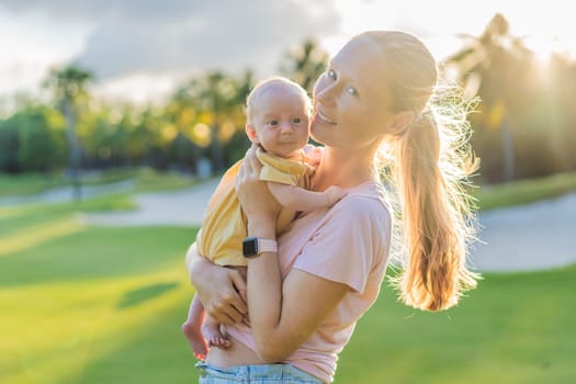 Young mother enjoying a peaceful walk in the park with her one-month-old baby. Motherhood, bonding, and outdoor family time concept.