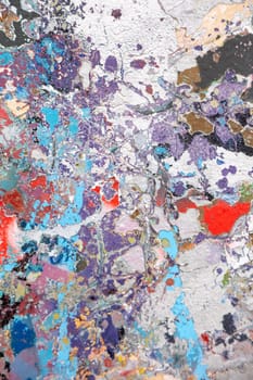 Abstract textured painting with bold splashes of blue, purple, and red. A visually striking composition ideal for backgrounds, creative design, and artistic projects