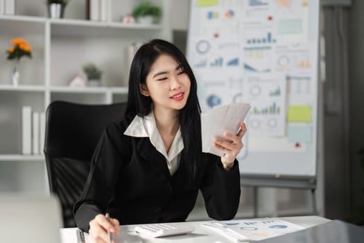 A cheerful accountant examines financial statements, showcasing a positive attitude in the office.