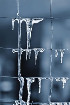 Beautiful icicles on the net. Concept for winter time, water and nature. Abstract background
