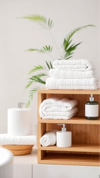 Spa treatment set, wooden shelf with neatly folded towels and dispensers for soap, cream, massage oil. High quality photo