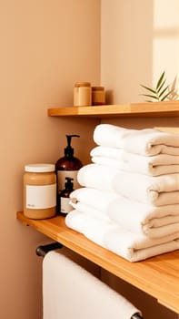 Spa treatment set, wooden shelf with neatly folded towels and dispensers for soap, cream, massage oil. High quality photo