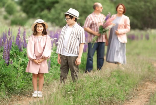 Happy caucasian family enjoying nature walk with lush flowers in blooming meadow.