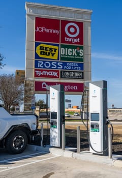 New Braunfels, TX - 1 March 2025: Hummer SUV truck being charged at Electrify America Hyperfast 350KW charging station in Texas