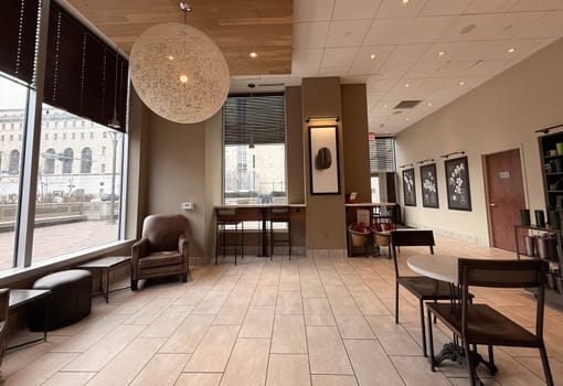 cozy cafe interior featuring stylish furniture, subdued lighting, and a warm, welcoming ambiance ideal for relaxation, conversation, and enjoying a cup of coffee or tea, good for multimedia content creation