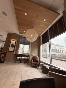 cozy cafe interior featuring stylish furniture, subdued lighting, and a warm, welcoming ambiance ideal for relaxation, conversation, and enjoying a cup of coffee or tea, good for multimedia content creation