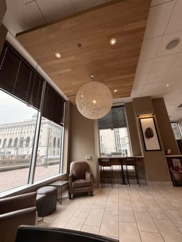 cozy cafe interior featuring stylish furniture, subdued lighting, and a warm, welcoming ambiance ideal for relaxation, conversation, and enjoying a cup of coffee or tea, good for multimedia content creation