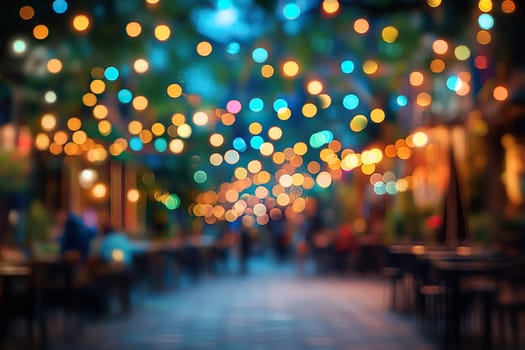 Blurred image of a pedestrian street with cafes and garlands.