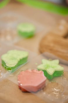 green and pink handmade soap in plastic mold