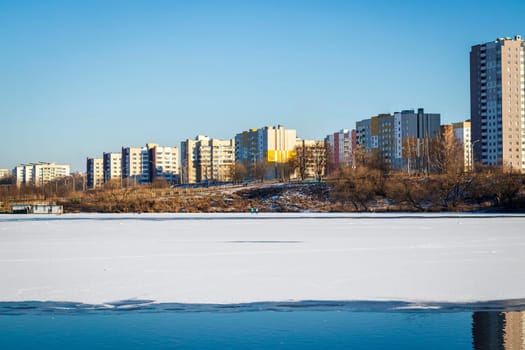 Frozen pond with urban background