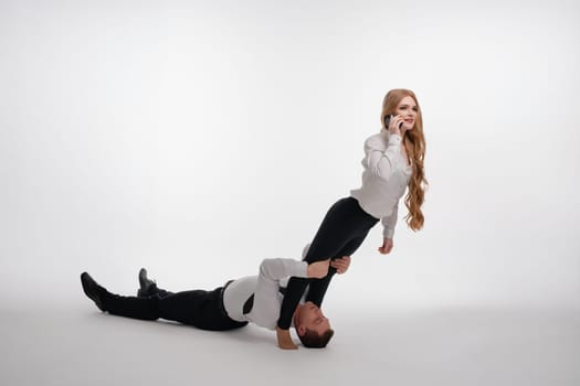A couple enthusiastically showcases their relationship while engaged in a fitness exercise that emphasizes teamwork.