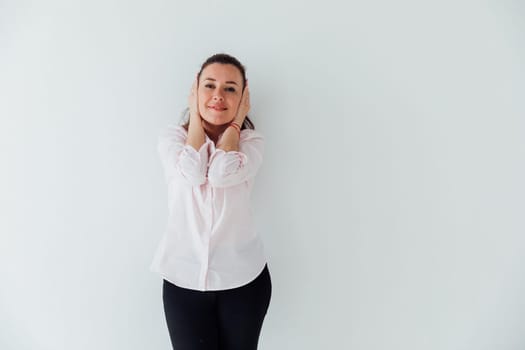 Portrait of a woman of 40 years old in a business suit near a white wall