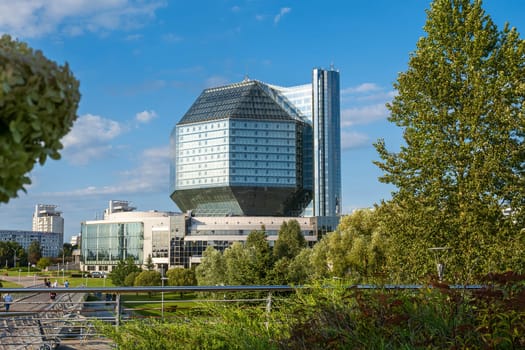 Minsk, Belarus - 08.16.24. The National Library of Belarus against a blue sky, a modern architectural landmark of the capital and a symbol of knowledge in geometric form.