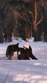 playing with a dog in nature. Doberman puppy with his owner. running with a puppy in the forest. winter frosty day in nature. puppy playing with its owner. raising a dog.