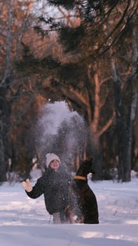 playing with a dog in nature. Doberman puppy with his owner. running with a puppy in the forest. winter frosty day in nature. puppy playing with its owner. raising a dog.