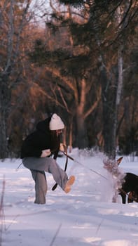 playing with a dog in nature. Doberman puppy with his owner. running with a puppy in the forest. winter frosty day in nature. puppy playing with its owner. raising a dog.
