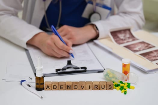 A doctor is analyzing the adenovirus while reviewing medications and documents in a clinical setting