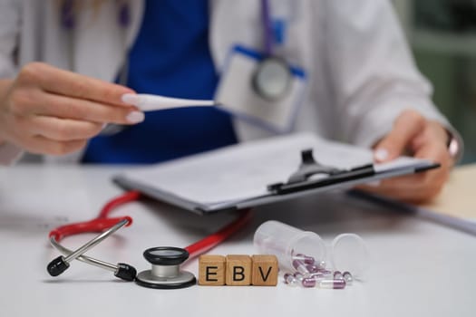 A healthcare professional checks a patients temperature and thoroughly reviews their medical records