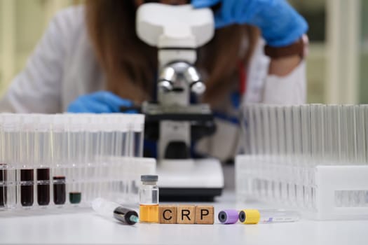 A skilled lab technician meticulously examines various samples for CRP analysis using a highpowered microscope