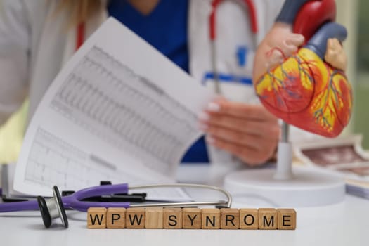 A dedicated medical professional meticulously analyzes WPW syndrome using a heart model and various data sheets