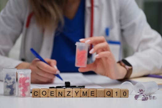 A qualified healthcare professional thoroughly examines Coenzyme Q10 dietary supplements for a patient