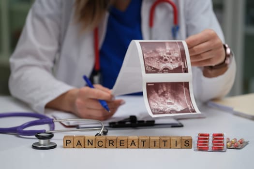 A dedicated healthcare professional meticulously reviewing pancreatitis images with medication spread across the table