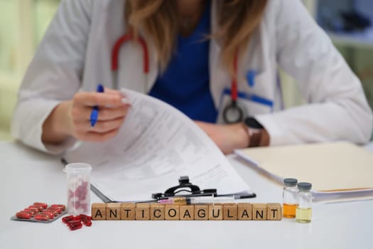 A dedicated healthcare worker analyzes anticoagulant treatments involving medications and paperwork