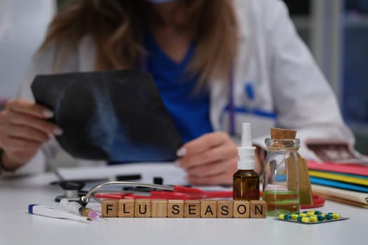 A medical professional carefully examines an Xray, highlighting the importance of flu season preparedness