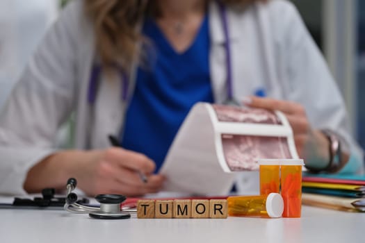 The doctor is examining tumor details, using various medications and essential medical tools in the clinic