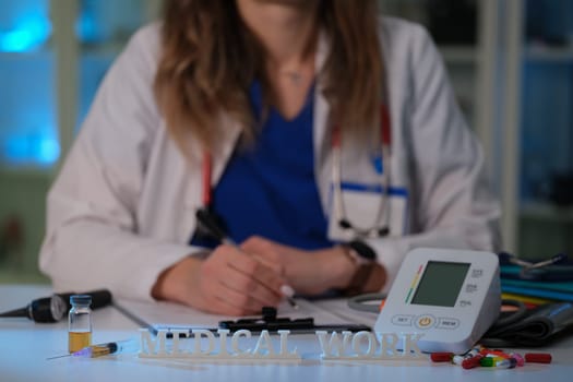 A dedicated healthcare professional dressed in medical scrubs is effectively working with essential medical equipment