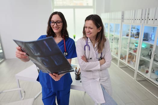 In a bright and contemporary healthcare setting, two dedicated professionals engage in discussing an Xray