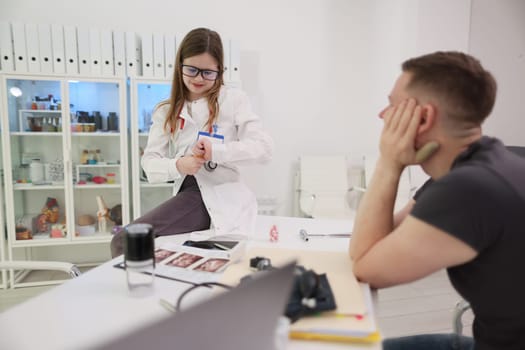 A healthcare professional carefully examines a patient within a bright and wellorganized clinical environment