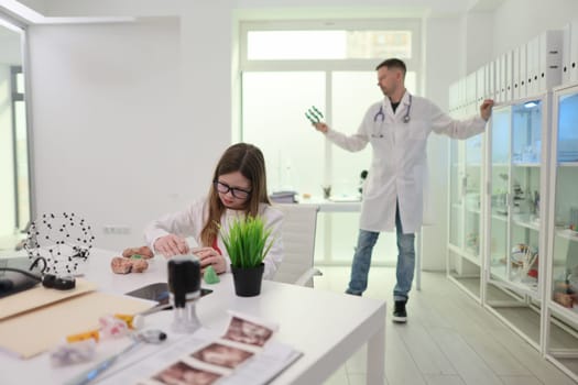 A dedicated young researcher works as a scientist overseeing tasks in a bright, wellequipped laboratory