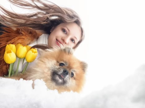 A mother and daughter share a happy moment as they walk through a sunny field filled with dandelions and blooming flowers, creating joyful memories.
