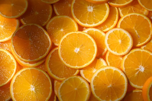 Bright and juicy orange slices spread out under warm sunlight, creating a lively, energetic feast for the eyes.