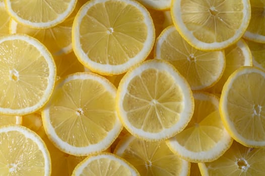 Lemon slices showcase their juicy, yellow interior, perfect for adding zest to drinks and dishes.