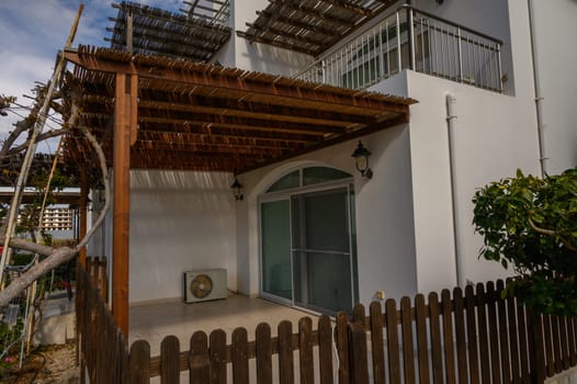 An inviting outdoor area with a wooden trellis offers a tranquil space for relaxing in nature.