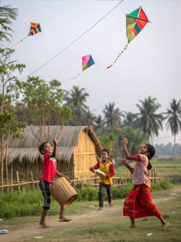 A lively scene of children playing and laughing during Bohag Bihu. Kids playing and laughing while flying colorful kites and throwing a balloon in a rural Indian village