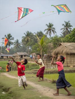 A lively scene of children playing and laughing during Bohag Bihu. Kids playing and laughing while flying colorful kites and throwing a balloon in a rural Indian village