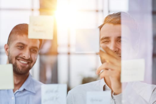 two successful businessmen in the office discuss a plan in office