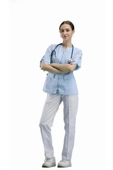 A full-length female doctor on a white background crossed her arms.