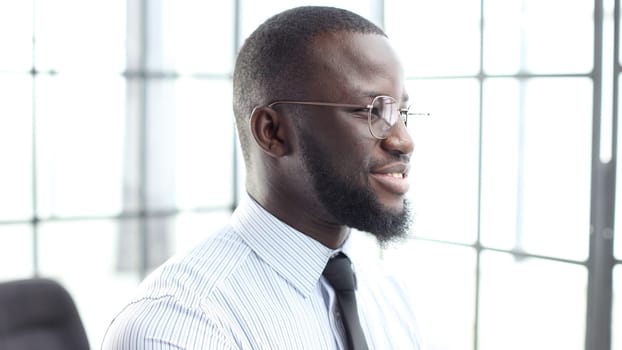 The face of a businessman man in a shirt is a close-up in the office.