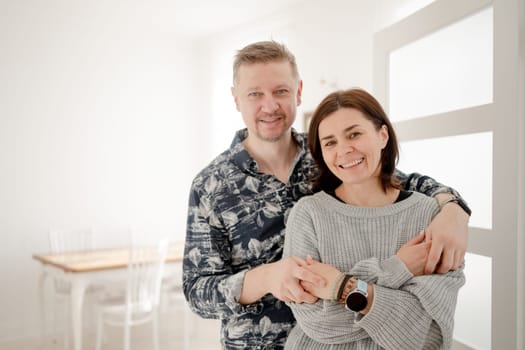 Happy Married Couple In A Bright Room