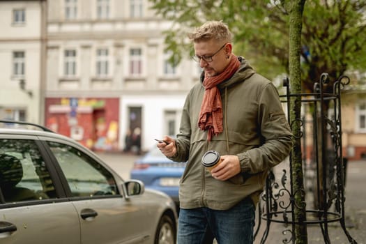 Young Man Uses Wireless Key To Open Parked Car Remotely On A City Street