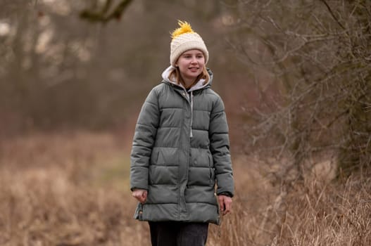 Girl Against Blurred Forest Background In Spring