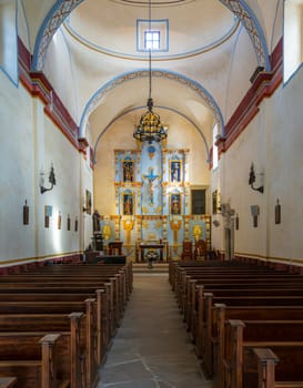 Interior of historic San Jose mission church near San Antonio, Texas, with ornate altar and statues