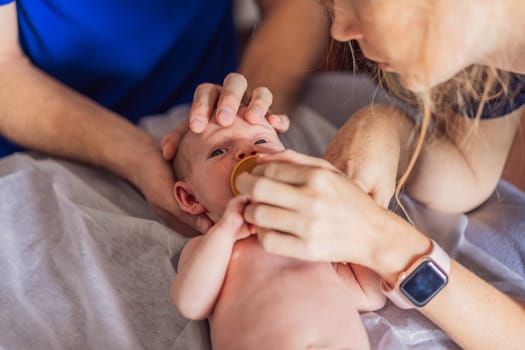 A newborn baby receives gentle osteopathic care, lying calmly while the specialist carefully examines and adjusts the infant. A moment of professional pediatric care, early development, and holistic well-being, symbolizing health and nurturing touch.